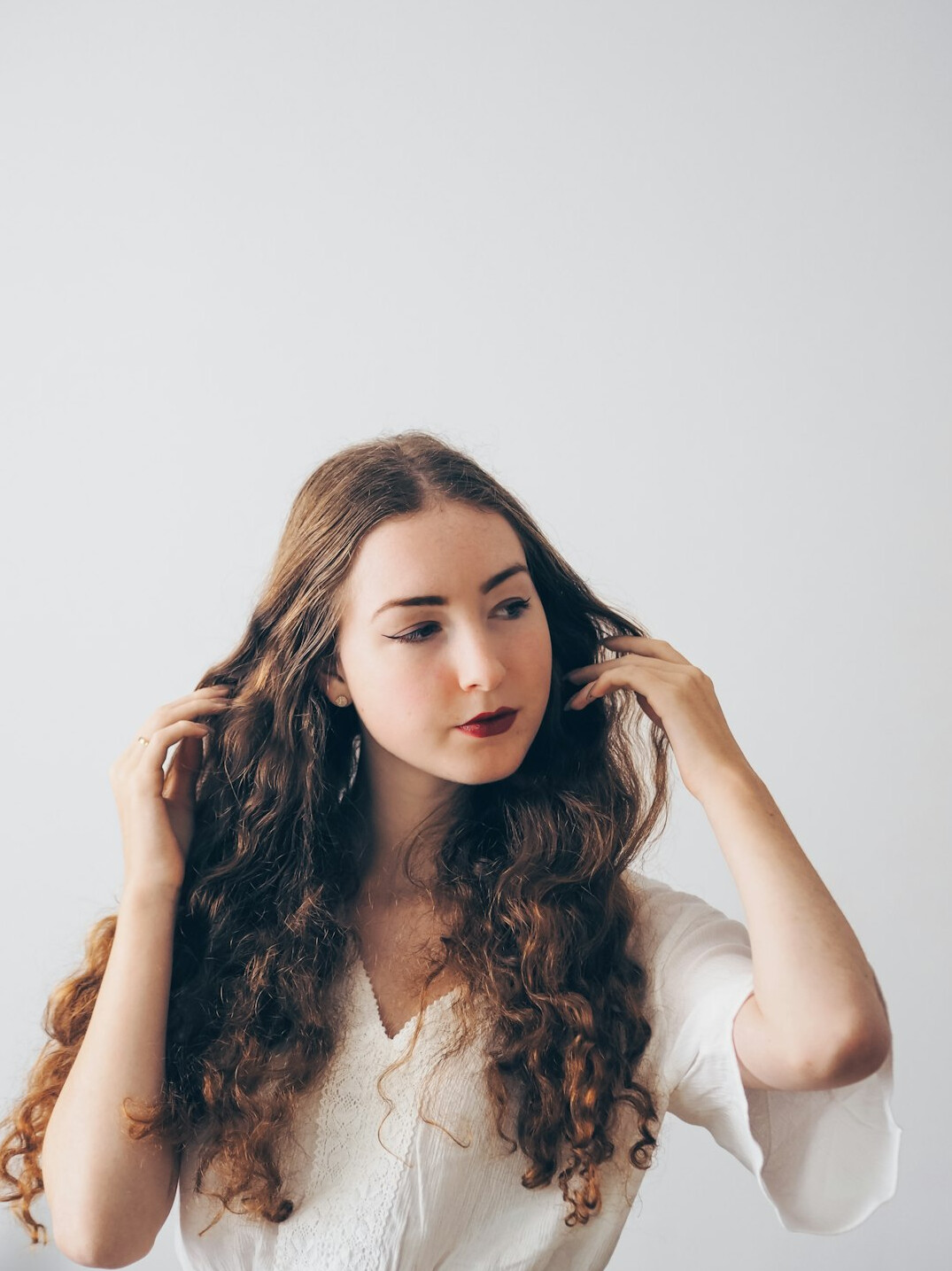 Studio portrait of a young woman with curly hair