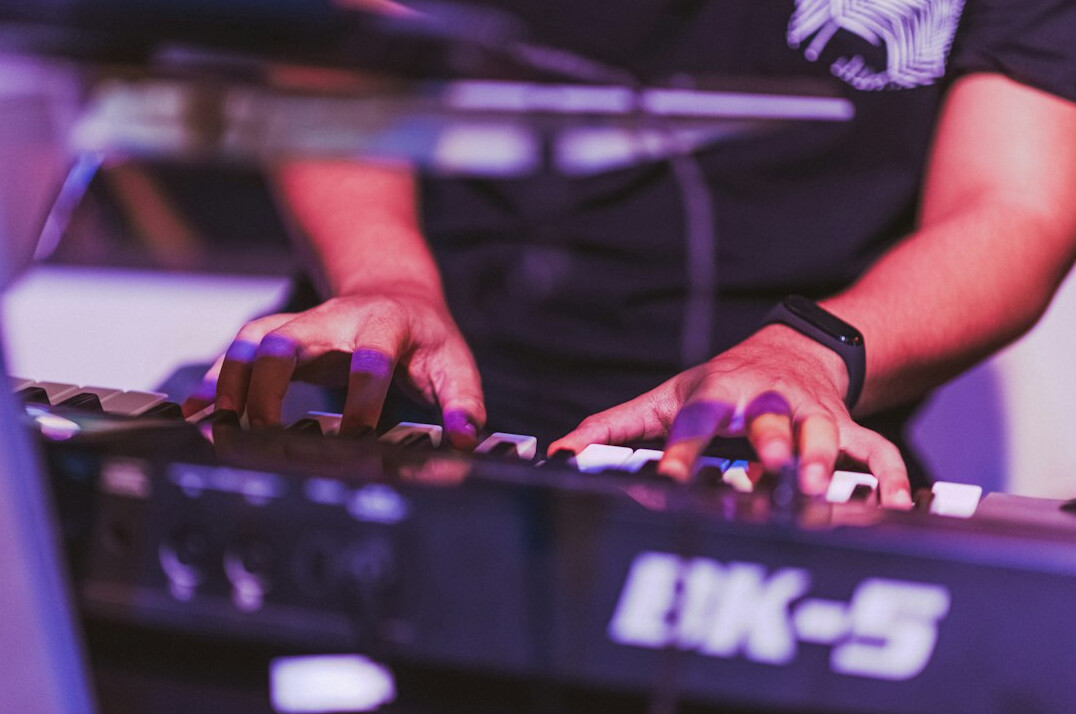 Close-up of hands typing code on a laptop keyboard