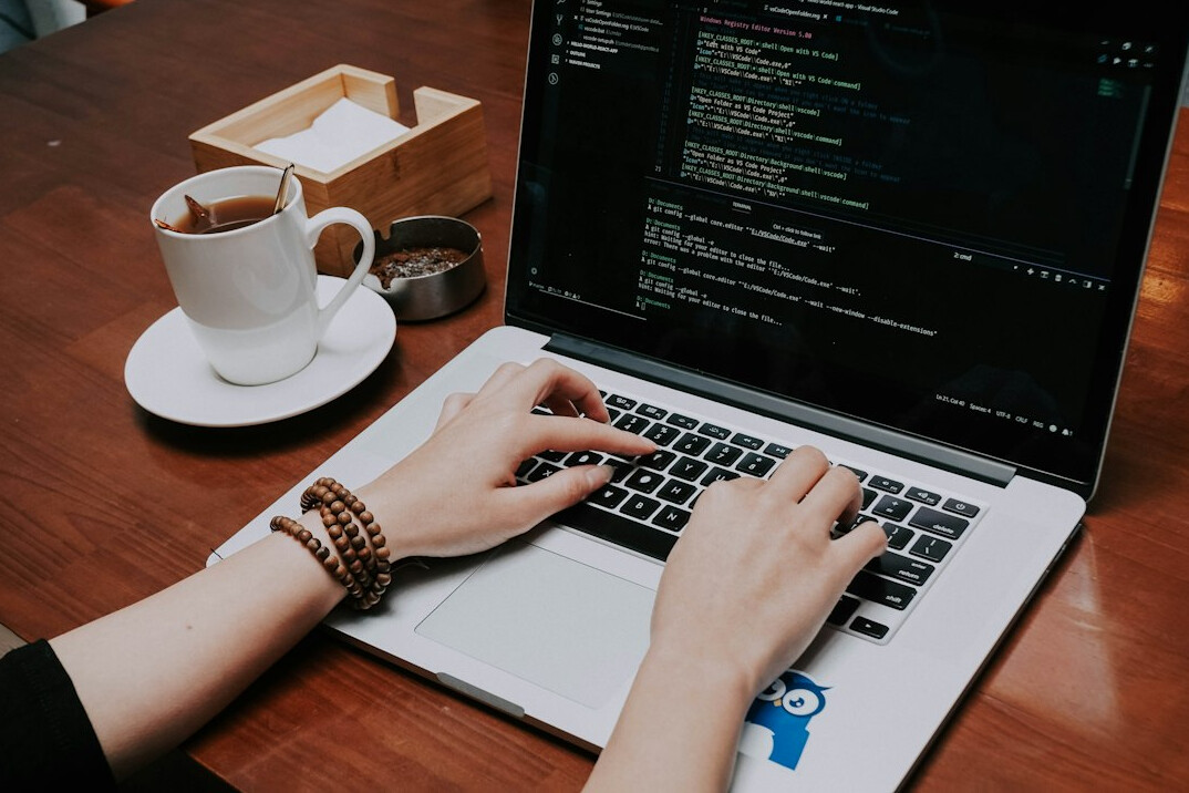 developer coding on laptop