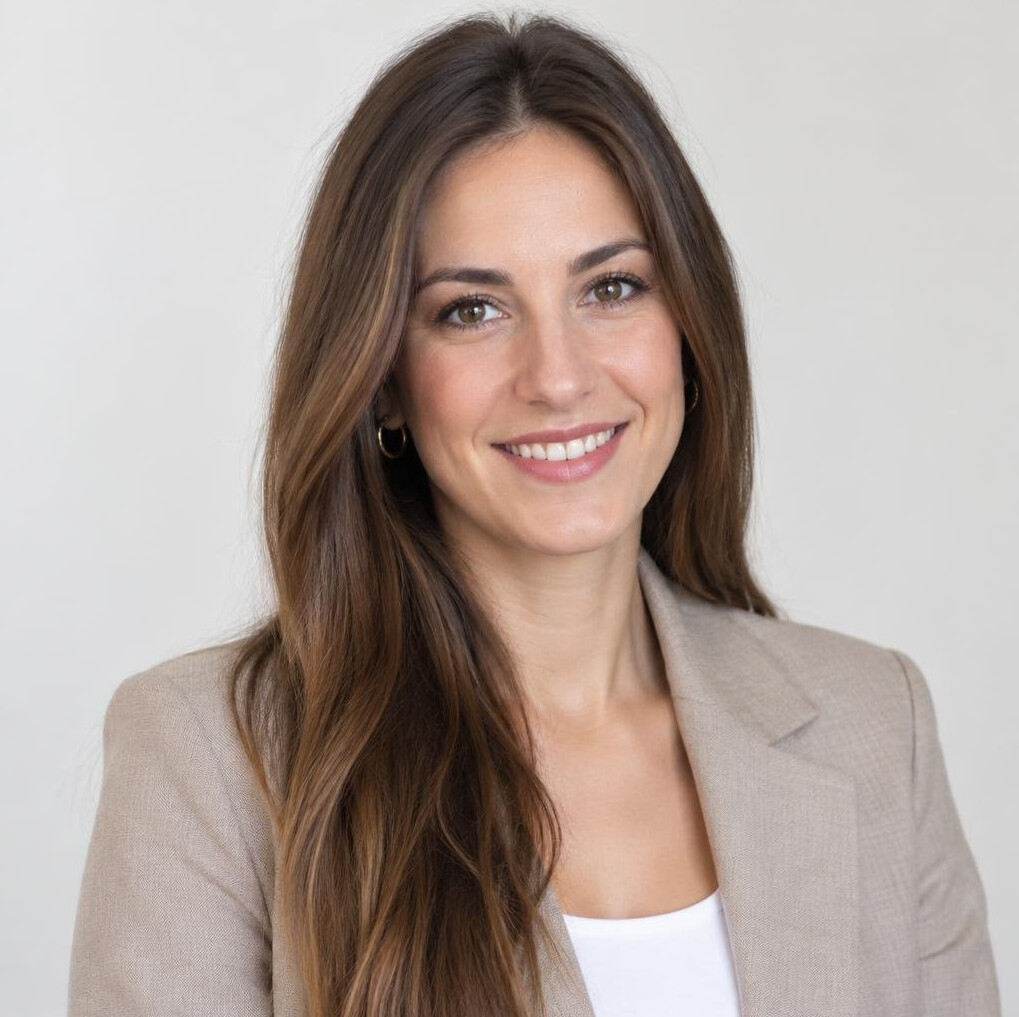 Studio portrait of a smiling woman with long brown hair