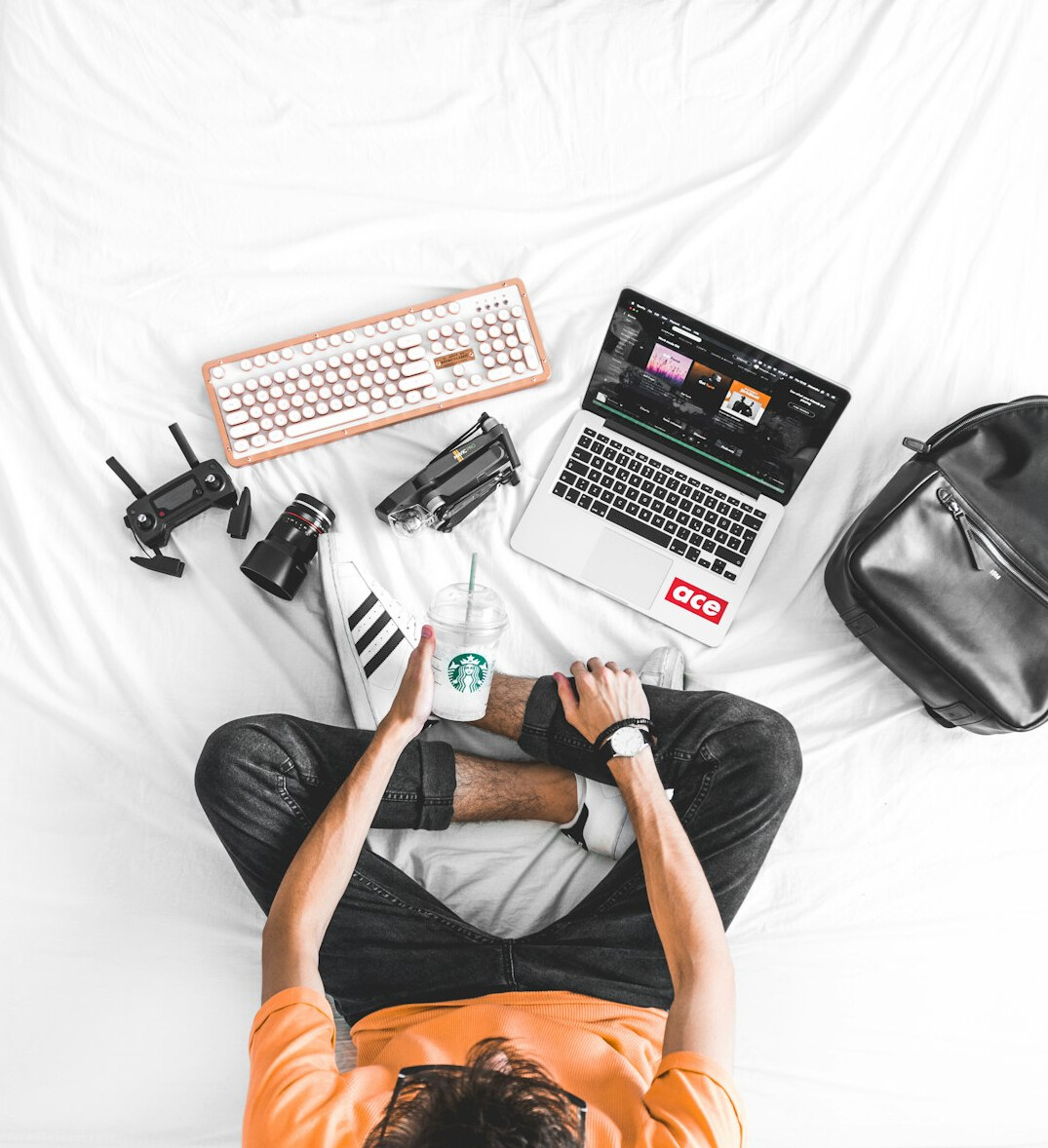 Young man writing code on a laptop at a bright desk